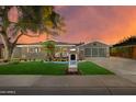Charming home with well-manicured lawn, landscape lighting, and stylish curb appeal at 8229 E Devonshire Ave, Scottsdale, AZ 85251