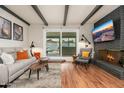 Living room with natural light, a fireplace, and seamless indoor-outdoor flow to the backyard pool at 8431 E Rose Ln, Scottsdale, AZ 85250