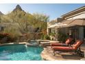Relaxing backyard pool and spa with comfortable lounge chairs, mature landscaping and desert mountain views at 10040 E Happy Valley Rd # 2022, Scottsdale, AZ 85255