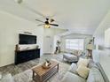 Bright and airy living room with vaulted ceilings, ceiling fan, and stylish furnishings at 1005 W 19Th Ave, Apache Junction, AZ 85120