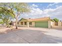 Inviting one-story home featuring desert landscaping and a spacious driveway leading to the attached garage at 1237 E Gemini Dr, Tempe, AZ 85283