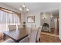 Well-lit dining room offering a wood table with seating for six and chandelier at 1459 S Mara Dr, Apache Junction, AZ 85120