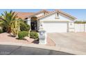 Beautiful single-story home with desert landscaping, including mature trees, and an attached two-car garage at 15516 W Verde Ln, Goodyear, AZ 85395