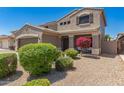 Charming two-story home featuring desert landscaping, a two-car garage, and a cozy front porch at 15604 N 173Rd Ln, Surprise, AZ 85388