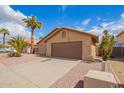 Charming single-story home features a low maintenance front yard and attached two-car garage at 15645 W Hilton Ave, Goodyear, AZ 85338