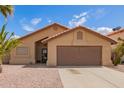 Charming single-story home features a low maintenance front yard and attached two-car garage at 15645 W Hilton Ave, Goodyear, AZ 85338