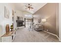 Bright living room features a vaulted ceiling, a fireplace, and sliding glass doors to the backyard at 15645 W Hilton Ave, Goodyear, AZ 85338