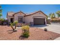 Home exterior with well-maintained desert landscaping and low maintenance front yard at 15903 N 138Th Ave, Surprise, AZ 85374