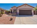 Home exterior with brick accents on front porch and desert landscaping for low maintenance living at 15903 N 138Th Ave, Surprise, AZ 85374