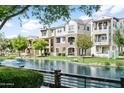 Scenic exterior view of townhomes with water feature and landscaping at 1661 E Hampton Ln, Gilbert, AZ 85295