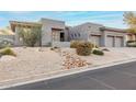 Modern home with desert landscaping, rocks, and low-water plants for an inviting curb appeal at 16670 N 109Th Way, Scottsdale, AZ 85255