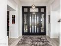 Grand foyer featuring decorative front doors, a chandelier, and wood-style tile flooring at 16670 N 109Th Way, Scottsdale, AZ 85255
