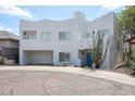 Contemporary two-story home with a striking white exterior, two-car garage and drought-tolerant landscaping at 1731 E Evans Dr, Phoenix, AZ 85022
