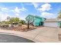 Charming two-story home with a manicured front yard featuring rock landscaping and mature trees at 1822 N Sunaire Cir, Mesa, AZ 85205