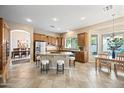 Spacious kitchen boasts stainless steel appliances, granite countertops, and a breakfast bar with ample seating at 2069 S Sailors Ct, Gilbert, AZ 85295