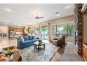 Cozy living room features a stone fireplace, hardwood floors, and opens to a modern kitchen at 2069 S Sailors Ct, Gilbert, AZ 85295