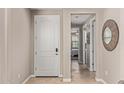 Bright entryway with wood-look tile flooring and access to a 'Bath' and what appears to be a bedroom at 20698 W Meadowbrook Ave, Buckeye, AZ 85396