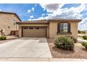 A beautiful home with a large driveway and a two-car garage with unique windows at 20941 E Pecan Ln, Queen Creek, AZ 85142
