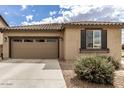 Charming single-story home featuring a tile roof, two-car garage, and neat desert landscaping at 20941 E Pecan Ln, Queen Creek, AZ 85142