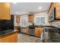Updated kitchen showcasing stainless steel appliances, granite countertops, and ample cabinetry at 2131 W Verde Ln, Phoenix, AZ 85015