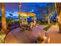 Inviting outdoor patio with dining set and comfortable seating area overlooking the golf course at 22912 N San Ramon Ct, Sun City West, AZ 85375