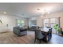 Spacious open-plan living area features updated flooring, natural light, and contemporary decor at 2939 W Sunshine Butte Dr, San Tan Valley, AZ 85144