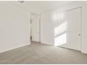 Carpeted bedroom with a window, a closet, and an open door at 37325 W San Clemente St, Maricopa, AZ 85138