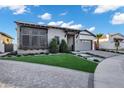 Lovely single-story house featuring well-maintained landscaping, metal roof, and brick driveway at 3842 E Alameda Ln, Gilbert, AZ 85298