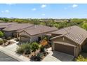 Birds eye view of multiple houses featuring a two car garage and tile roofing at 40055 N High Noon Way, Anthem, AZ 85086