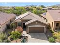 A cozy single-story home is shown from above, featuring a two-car garage and tile roofing at 40055 N High Noon Way, Anthem, AZ 85086