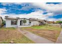 Charming single-story home with a well-maintained front yard and inviting curb appeal at 4213 W Medlock Dr, Phoenix, AZ 85019