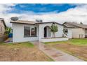 Charming single-story home with a well-maintained front yard and inviting curb appeal at 4213 W Medlock Dr, Phoenix, AZ 85019
