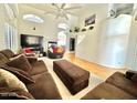 Spacious living room with high ceilings, fireplace, and many windows at 4446 E Woodridge Dr, Phoenix, AZ 85032