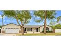 Charming single-story home with a well-manicured lawn and mature trees at 4611 E Monterosa St, Phoenix, AZ 85018