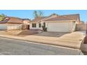 Single-story home featuring a two-car garage, desert landscaping, and a well-maintained front yard at 5029 N 86Th Dr, Glendale, AZ 85305