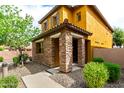 Charming two-story home featuring a stone facade, low maintenance desert landscaping, and covered entry at 5436 W Chisum Trl, Phoenix, AZ 85083