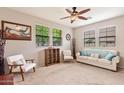 Inviting living room featuring a ceiling fan, large windows, and comfortable seating at 5436 W Chisum Trl, Phoenix, AZ 85083