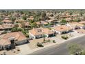 Neighborhood aerial view featuring the home's desert landscaping, mature trees and well-maintained exterior at 5719 E Paradise Ln, Scottsdale, AZ 85254