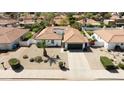 Expansive aerial view showcasing the home's tile roof, xeriscaping, and landscaping in a neighborhood setting at 5719 E Paradise Ln, Scottsdale, AZ 85254