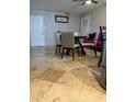 Cozy dining area with table and chairs adjacent to a living space at 5815 N 61St Ln, Glendale, AZ 85301