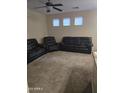 Spacious living room with three windows for natural light and a ceiling fan at 6629 W Polk St, Phoenix, AZ 85043