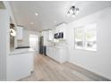 Bright, open kitchen with white cabinets, stainless steel appliances, and wood-look flooring at 7041 E Cypress St St, Scottsdale, AZ 85257