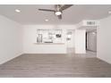 Spacious living room with new gray flooring and open view into the kitchen at 7041 E Cypress St St, Scottsdale, AZ 85257