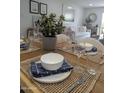 Dining room table setting with living room and white sofa in the background at 7350 N Via Paseo Del Sur -- # P107, Scottsdale, AZ 85258