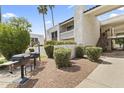 Well-maintained condo exterior featuring a private outdoor grill area and lush landscaping, perfect for relaxed outdoor living at 7350 N Via Paseo Del Sur -- # P107, Scottsdale, AZ 85258