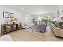 Bright, airy living room with hardwood floors, a plush white sofa, and a seamless indoor-outdoor flow at 7350 N Via Paseo Del Sur -- # P107, Scottsdale, AZ 85258