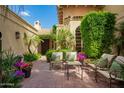 Charming courtyard with brick flooring, lush landscaping, and comfortable seating at 7500 E Mccormick Pkwy # 73, Scottsdale, AZ 85258
