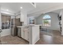 Bright kitchen with stainless steel appliances, a breakfast bar, and an open view into the living area at 7675 E Mcdonald Dr # 107, Scottsdale, AZ 85250