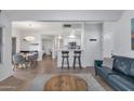 Open-concept living space with bar seating, dining area, and comfortable seating, flowing seamlessly at 7675 E Mcdonald Dr # 107, Scottsdale, AZ 85250