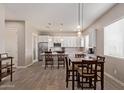 Spacious open-concept kitchen with white cabinets, stainless steel appliances, and an adjacent dining area at 8026 S 6Th Dr, Phoenix, AZ 85041